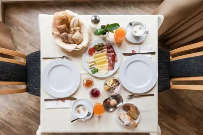 a white table with breakfast foods on it at Hotel Weger in Tirolo