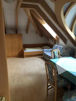 a living room with a table and chairs and a couch at Hotel Residence Lorenz in Colle Isarco