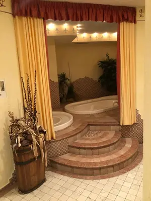 a bathroom with a tub and a toilet in a room at Hotel Residence Lorenz in Colle Isarco