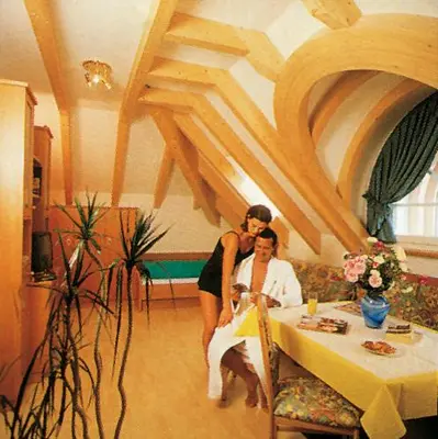 a woman standing next to a woman sitting at a table at Hotel Residence Lorenz in Colle Isarco