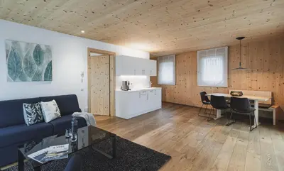 a living room with a couch and a table at Residence Nives in Bressanone