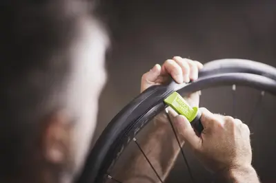 a man is holding a wheel with a green handle at Residence Nives in Bressanone