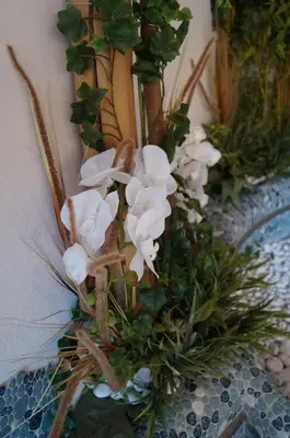 a vase filled with white flowers on a table at Hotel Laurin in Tires