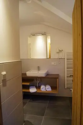 a bathroom with a sink and a mirror at Hotel Laurin in Tires