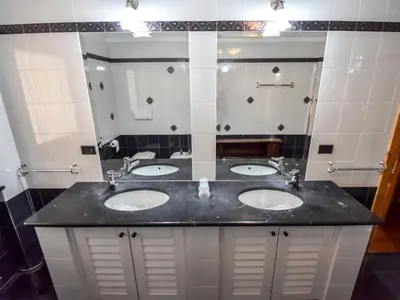 a bathroom with two sinks and a shower at Chalet Cesa Galadriel-1 by Interhome in Penia
