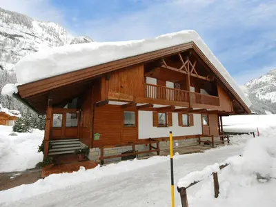 a house with flowers on the front of it at Chalet Cesa Galadriel-1 by Interhome in Penia