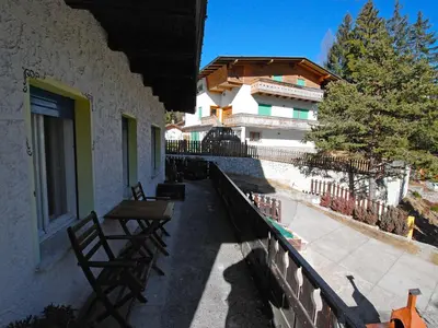 a balcony with two benches and a building at Apartment La Busa-1 by Interhome in Masarè