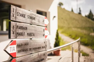 a stack of wooden signs next to a house at Gasthof Jaufensteg in Racines