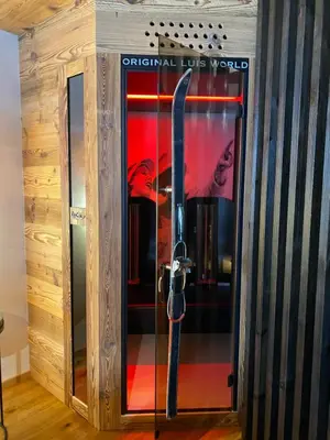 a glass door with a skis inside of it at Alpine Refuge Villa Adler in San Vigilio Di Marebbe