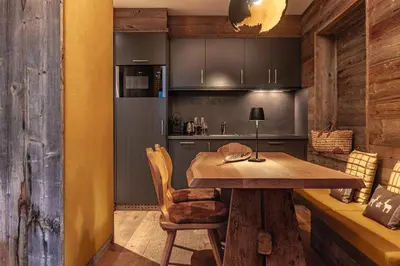 a kitchen with a wooden table in a room at Alpine Refuge Villa Adler in San Vigilio Di Marebbe