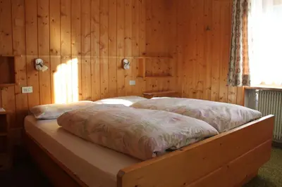 a bedroom with a bed sitting on a patio at CIADIN APPART. in Badia