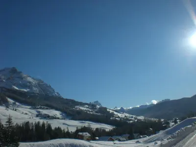 a large mountain with trees in front of it at CIADIN APPART. in Badia