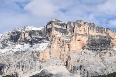 a mountain above a body of water with trees at CIADIN APPART. in Badia
