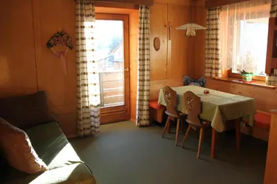 a bed in a room with a wooden wall at CIADIN APPART. in Badia