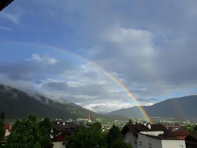 a rainbow in the sky over a city at App. Tamanhof in San Giorgio