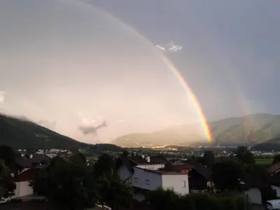 a rainbow in the sky over a city at App. Tamanhof in San Giorgio