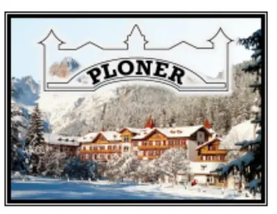 a picture of a hotel in the snow with a sign at Ploner villaggio Turistico in Dobbiaco