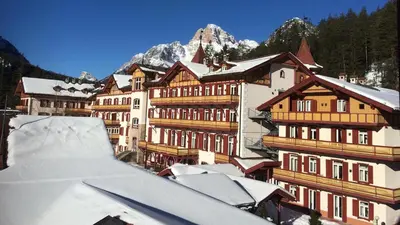 a group of buildings with snow covered roofs at Ploner villaggio Turistico in Dobbiaco
