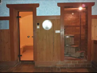 an open door in a room with a brick wall at Ploner villaggio Turistico in Dobbiaco