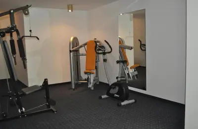 a gym with several exercise bikes and a mirror at Ploner villaggio Turistico in Dobbiaco
