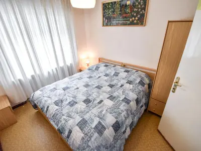 a bedroom with a bed and a large window at Apartment La Busa-2 by Interhome in Masarè