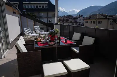 a balcony with a table and chairs on a balcony at Sunshine Apartments in Bolzano