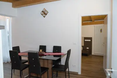 a dining room with a table and chairs at Sunshine Apartments in Bolzano