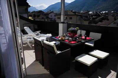 a balcony with a table and chairs on a balcony at Sunshine Apartments in Bolzano