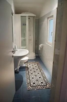 a bathroom with a sink and a toilet and a shower at Sunshine Apartments in Bolzano