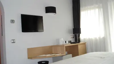 a room with a wooden wall with a desk and a chair at Hotel Garni Vittoria in Fiera di Primiero
