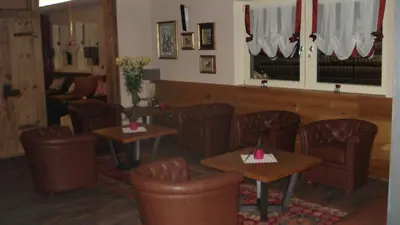 a restaurant with tables and chairs in a room at Hotel Garni Vittoria in Fiera di Primiero