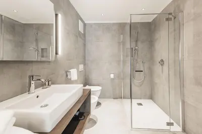 a bathroom with a sink and a shower and a toilet at Aquila Dolomites Residence in Ortisei