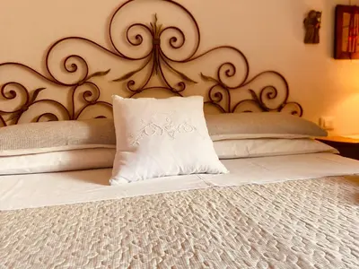 a white pillow sitting on top of a bed at B&B Pichler Casa in Castello di Fiemme