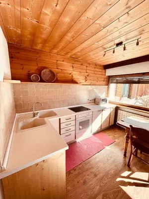 a kitchen with a sink and a counter top at B&B Pichler Casa in Castello di Fiemme