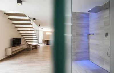 a bathroom with a staircase and a walk in shower at B&B Boutique Hotel Burgund in Parcines