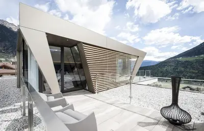 a glass house with a vase on a balcony at B&B Boutique Hotel Burgund in Parcines
