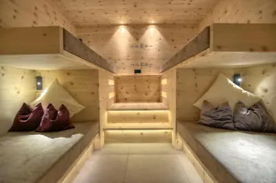 a room with two beds in a wooden room at B&B Boutique Hotel Burgund in Parcines