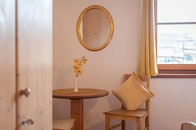 a bedroom with a bed and a crib at Weinberghof in Termeno