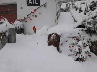 a yard covered in snow with christmas decorations at ATL AGRITURISMO in Salorno sulla Strada del Vino
