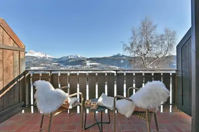 three white feathered birds sitting on a balcony at Panoramahotel Obkircher in Nova Ponente