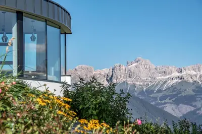 a house with a view of the mountains at Panoramahotel Obkircher in Nova Ponente