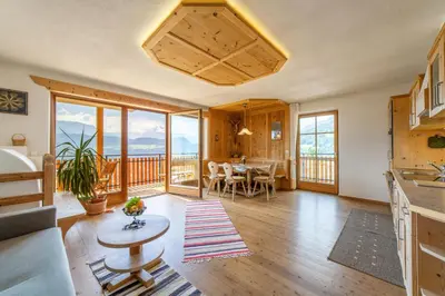 a kitchen and living room with a table and chairs at Huberhof in Villandro