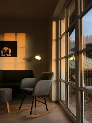 a kitchen with a wooden table and chairs and a window at Stern B&B & Apartments in Nova Levante