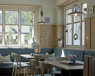 a restaurant with tables and chairs and windows at Stern B&B & Apartments in Nova Levante