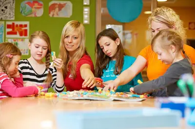 a group of children sitting at a table playing with toys at Familienhotel Maria in Obereggen