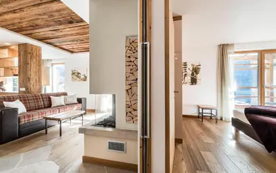 a living room with a couch and a fireplace at Apartments Chalet Anna in Ortisei