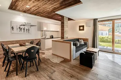 a kitchen and dining room with a table and chairs at Apartments Chalet Anna in Ortisei