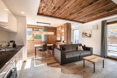 a living room with a couch and a table at Apartments Chalet Anna in Ortisei