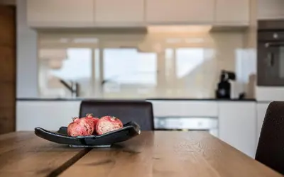 a plate of fruit on a table in a kitchen at Apartments Chalet Anna in Ortisei