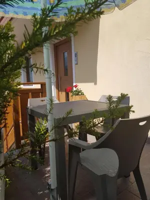 a table and chairs on a patio in a house at Casa Alice 5.3 in Fiera di Primiero